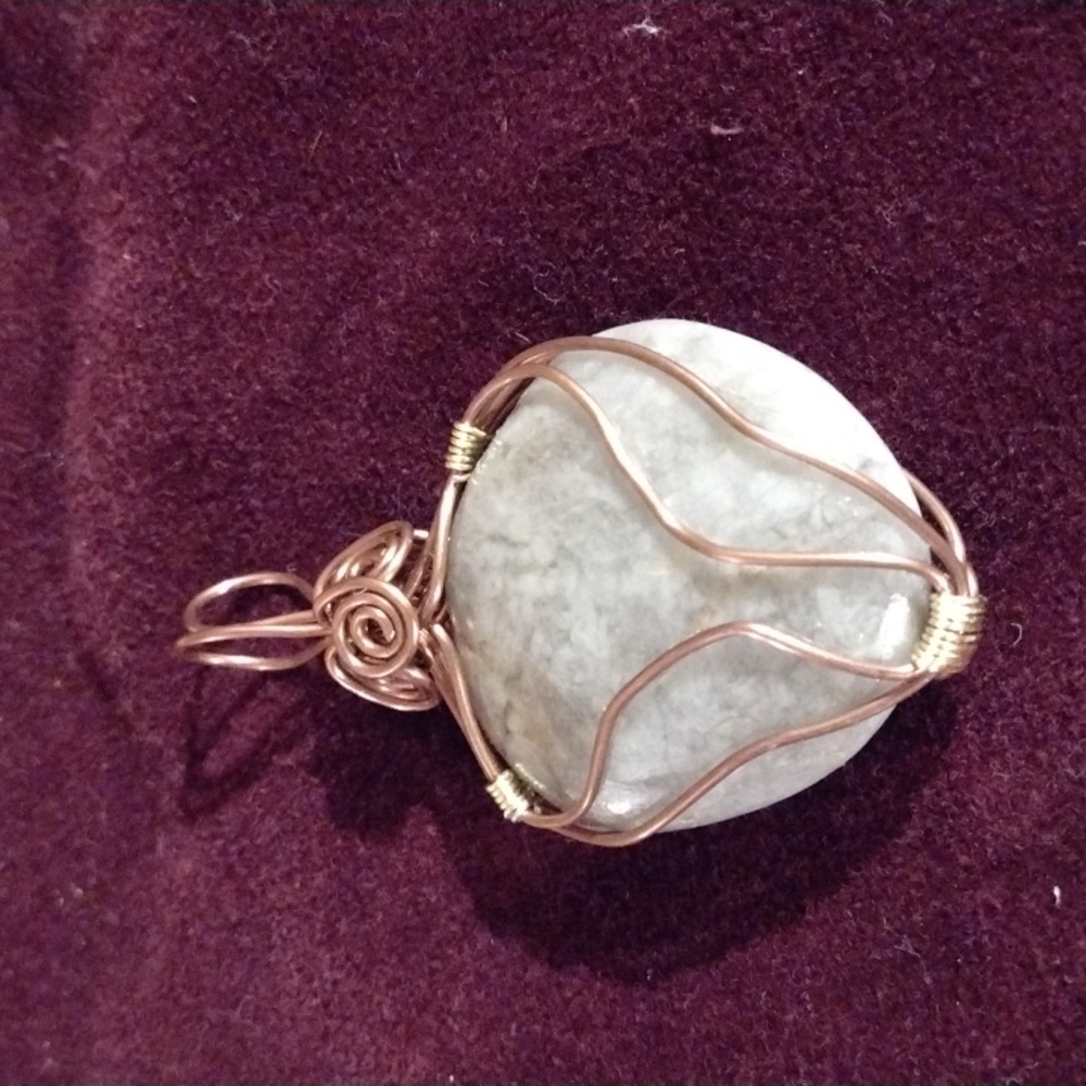 Grey stone pendant with copper wire